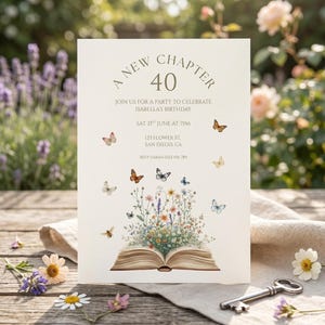 May include: A cream-colored invitation card with the text "A New Chapter 40" and event details. The card features illustrations of butterflies and flowers emerging from an open book, with a key on the table.
