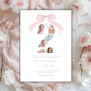 May include: A white invitation card featuring a pink bow and the number two, incorporating four photos of a child. The text reads "Olivia Is Turning Two!" and includes event details: date, time, and location.