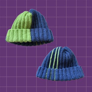 May include: Two crocheted beanies. The first beanie features a split design with one half in lime green and the other half in navy blue. The second beanie is navy blue with three vertical lime green stripes running from the crown to the brim.