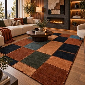 May include: A rectangular area rug featuring a grid of large, solid-colored squares in shades of deep navy blue, burnt orange, muted teal, and warm tan. The rug has a textured, tufted surface with visible stitching between each square block.