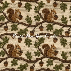May include: A cream-colored crochet fabric featuring a repeating pattern of brown squirrels holding acorns, dark brown tree branches, and green oak leaves. The text "Bears Den Handmade" is written in white cursive script across the center.