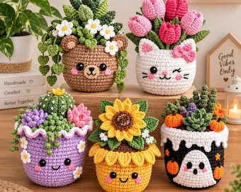 May include: Five crocheted plant pots with faces. One is a brown bear with succulents, one a white cat with pink tulips, one a purple pot with a cactus and flowers, one a yellow sunflower pot, and one a black pot with a ghost and pumpkins.