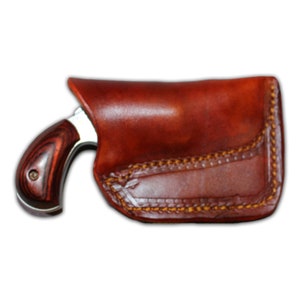 May include: A brown leather holster with a stitched design and a small silver revolver with a wood handle.