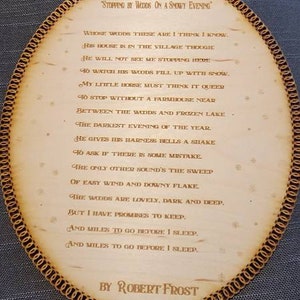 May include: A wooden plaque with a poem by Robert Frost titled "Stopping by Woods on a Snowy Evening". The poem is engraved in the wood and the plaque has a decorative border.