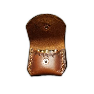 22 Magnum shell holder for pocket carry.  Made from high quality grade A Herman Oak leather.  Holds five shells finished In saddle tan.