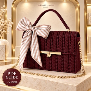 May include: A deep burgundy rectangular handbag with a textured, woven surface, a gold-tone metal clasp, and a gold chain strap. A large beige and white striped ribbon bow is tied to the top handle. The text PDF GUIDE + VIDEO is visible.