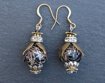A unique pair of handmade brass, silver, gold and black steam punk bead bee / beetle / insect earrings.