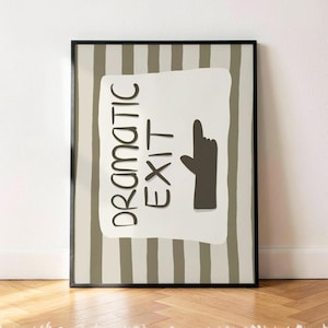 May include: A framed wall art print featuring a light beige background with vertical dark gray stripes. A central off-white rectangular shape contains the dark gray text "DRAMATIC EXIT" next to a dark gray hand icon pointing upward.