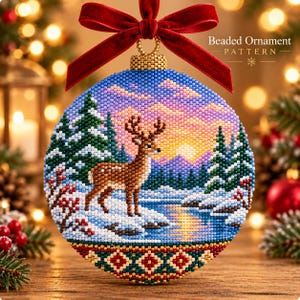 May include: A round beaded ornament featuring a deer standing in a snowy landscape with pine trees and a sunset sky. The ornament is topped with a red velvet ribbon bow and has a geometric pattern of red, green, and gold beads at the base.