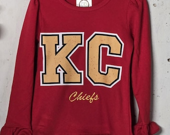 Inspired by Kansas City Chiefs football long sleeve shirt great for KC football fans