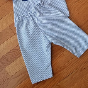 May include: Blue and white striped pants with a wide elastic waistband.