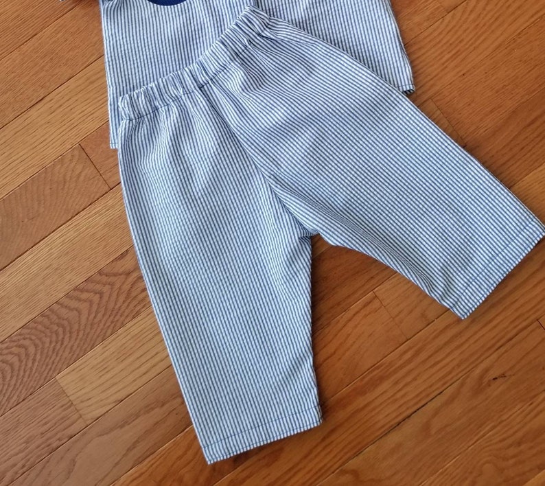 May include: Blue and white striped pants with a wide elastic waistband.