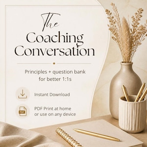May include: A digital document titled The Coaching Conversation, Principles + question bank for better 1:1s, featuring an instant download icon and a PDF icon. Beside it, a beige vase with dried grasses and a spiral notebook with a gold pen.