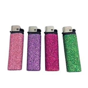 May include: Four lighters with glitter covers. The lighters are pink, purple, red, and green.