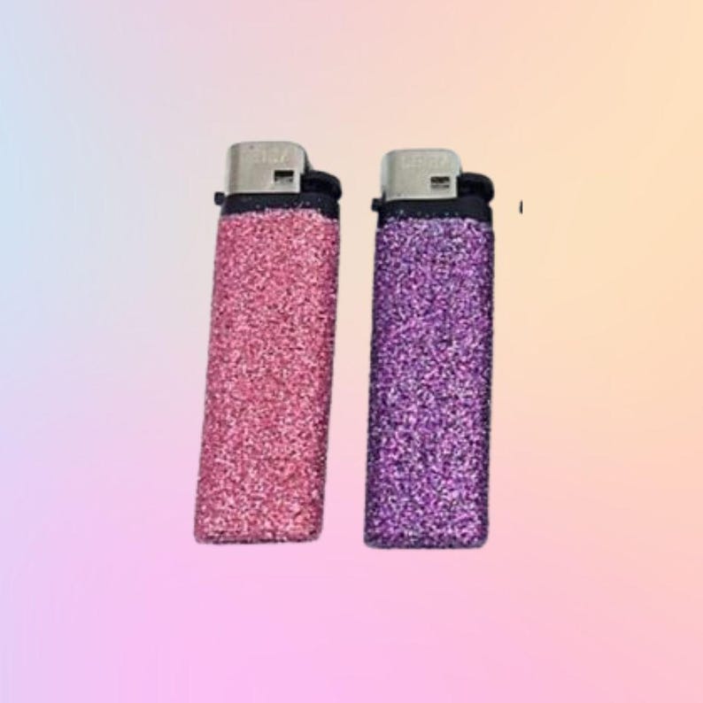 May include: Two glitter lighters, one pink and one purple.