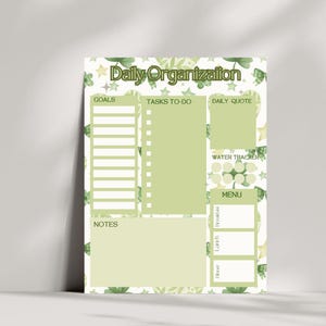 May include: A light green daily planner with the words "Daily Organization" at the top. The planner includes sections for goals, tasks, daily quotes, a water tracker, a menu, and notes. The design features a floral pattern.
