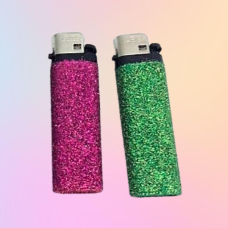 May include: Two lighters with glitter covers. One is pink and the other is green.