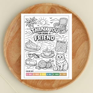 May include: A black and white color-by-number card with the text "THANK YOU FOR BEING A FRIEND". The image includes illustrations of a cake, teacup, cat, and other objects. A color key at the bottom provides color assignments.