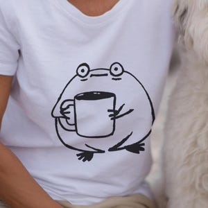 Grumpy Frog Holding Coffee Mug T-Shirt Funny Morning Mood Doodle Tee Cute Animal Lover Gift Unisex Deadpan Ink Art