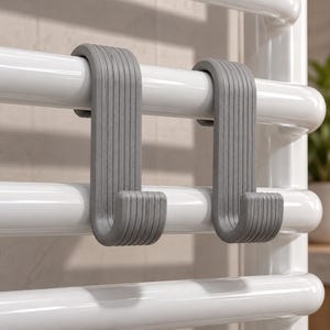 May include: Two grey S-shaped hooks with a ribbed texture, each designed to hang securely over a horizontal white cylindrical bar. The hooks feature a curved top and a J-shaped bottom, providing a functional solution for organising items.