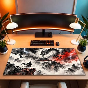 May include: A rectangular desk mat featuring a black and white ink-wash style illustration of a warrior standing on a cliff, a large dragon, a temple, and red accents with lightning bolts, placed on a wooden desk with a computer monitor and keyboard.