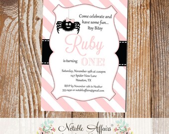 May include: Pink and white striped invitation with a black border. The invitation is for a first birthday party for a girl named Ruby. The invitation features a black spider with a pink bow. The text on the invitation reads "Come celebrate and have some fun... Itsy Bitsy Ruby is turning ONE!"
