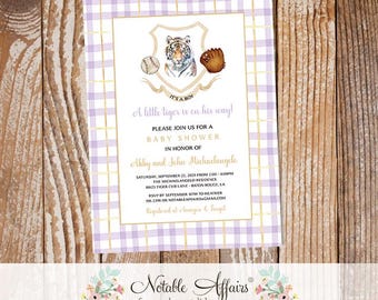 May include: A purple and white gingham baby shower invitation with a gold border. The invitation features a cartoon tiger wearing a baseball cap and holding a baseball bat. The text reads "It's a Boy! A little tiger is on his way! Please join us for a baby shower in honour of Abby and John Michaelangelo. Saturday, September 22, 2025 from 2:00-4:00pm. The Michelangelo Residence, 8423 Tiger Cub Lane, Baton Rouge, LA. RSVP by September 10th to Heather, 555.2398 or notableaffairs@gmail.com. Registered at Amazon & Target."