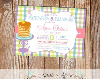 May include: A pink, yellow, and blue gingham patterned invitation for a 1st birthday party. The invitation says "Join us for Pancakes & Pajamas to celebrate Anna Claire's 1st Birthday. Saturday December 13 at 9:00 in the morning. Young Chef's Academy 7470 Jefferson Hwy, Ste E, Baton Rouge, LA. RSVP to 555-4489 or notableaffairs@gmail.com. Come dressed in your pajamas."