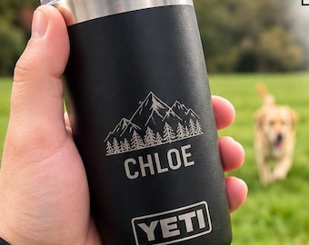May include: A black 10oz Yeti Rambler tumbler featuring a laser-engraved mountain graphic and the name Chloe. The product includes a MagSlider lid, and the image displays various colour options, custom engraving examples, and size variations.