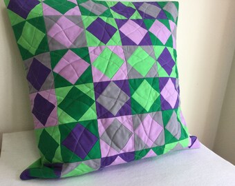 Quilted Pillow Cover in square on square design with solid colors of green, purple, gray and pinkish mauve