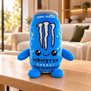 May include: A plush toy shaped like a blue Monster Energy Ultra Blue Hawaiian drink can. It features a white claw logo, a smiling face with black eyes, two arms, and two feet. The text reads ZERO SUGAR, MONSTER ENERGY, and ULTRA BLUEHAWAIIAN.