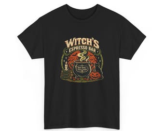 May include: A black t-shirt featuring a graphic print of a cauldron with steam, a pumpkin, a black cat, and books. The text reads Witch's Espresso Bar and Dark Roast Extra Cackle. The design includes a red moon background with bats.