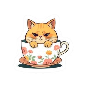 May include: A sticker featuring an orange tabby cat with a grumpy expression sitting inside a white teacup. The teacup and matching saucer are decorated with a pattern of small pink, orange, and yellow flowers with green stems and leaves.