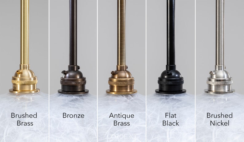May include: Five different finishes for a pendant light fixture. The finishes are brushed brass, bronze, antique brass, flat black, and brushed nickel.
