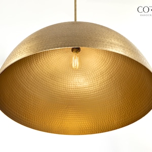 May include: A gold hammered metal pendant light fixture with a single bulb.