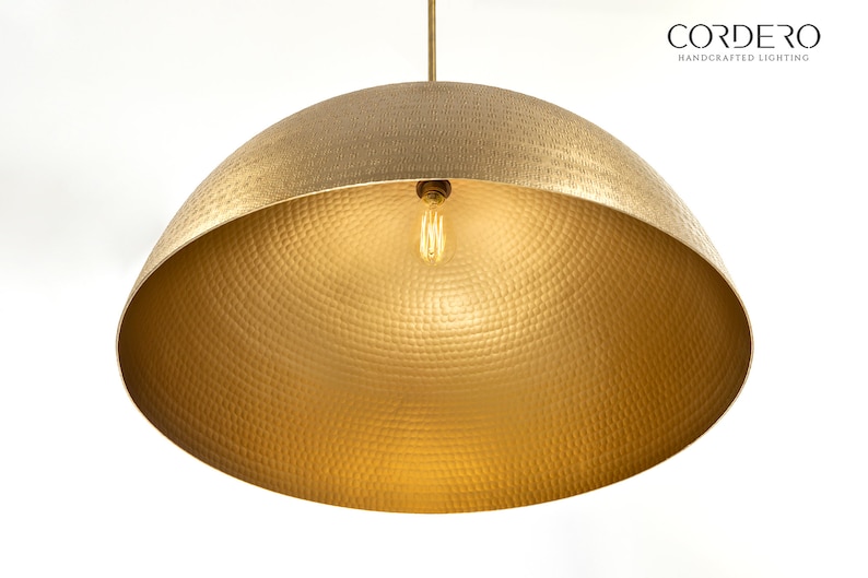 May include: A gold hammered metal pendant light fixture with a single bulb.