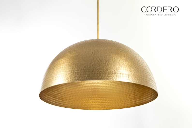 May include: A gold hammered metal dome pendant light fixture.  CORDERO HANDCRAFTED LIGHTING is printed in black text on a white background.