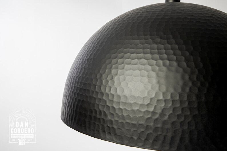 May include: A black hammered metal dome pendant light fixture.