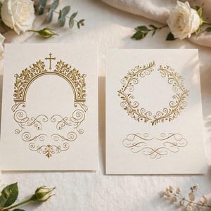 May include: Two rectangular off-white cards featuring intricate gold foil designs. The left card displays an arched frame topped with a cross and ornate scrollwork. The right card features a circular floral wreath and a decorative flourish below.