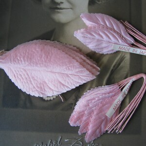 Op de afbeelding: Drie roze stoffen bladeren met draadstengels. De bladeren zijn gelaagd en hebben een textuur. De bladeren zijn gelabeld met "Made in Japan".