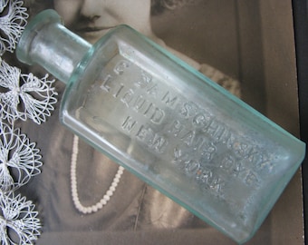 Botella antigua en relieve azul agua, tinte líquido para el cabello de G. Damschinsky