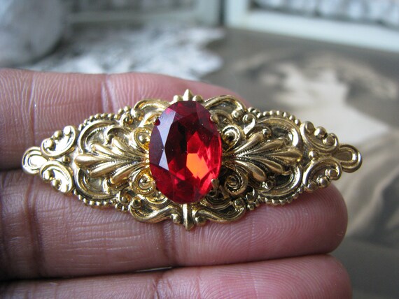 Red jewel sales brooch