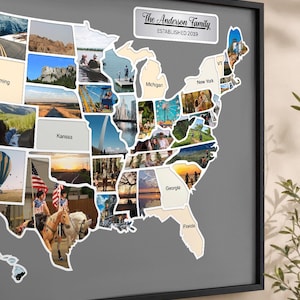 May include: A framed wall map of the United States featuring a collage of photographs within the state borders. A white rectangular plaque at the top reads The Anderson Family ESTABLISHED 2019. Some states are labeled with text like Kansas and Florida.
