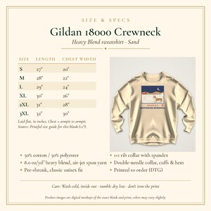 May include: A sand-colored Gildan 18000 crewneck sweatshirt featuring a graphic of a corgi in a snowy landscape with the text 'HEAD OF REINDEER HERDING'. The image includes a size chart with measurements in inches for sizes S through 3XL.
