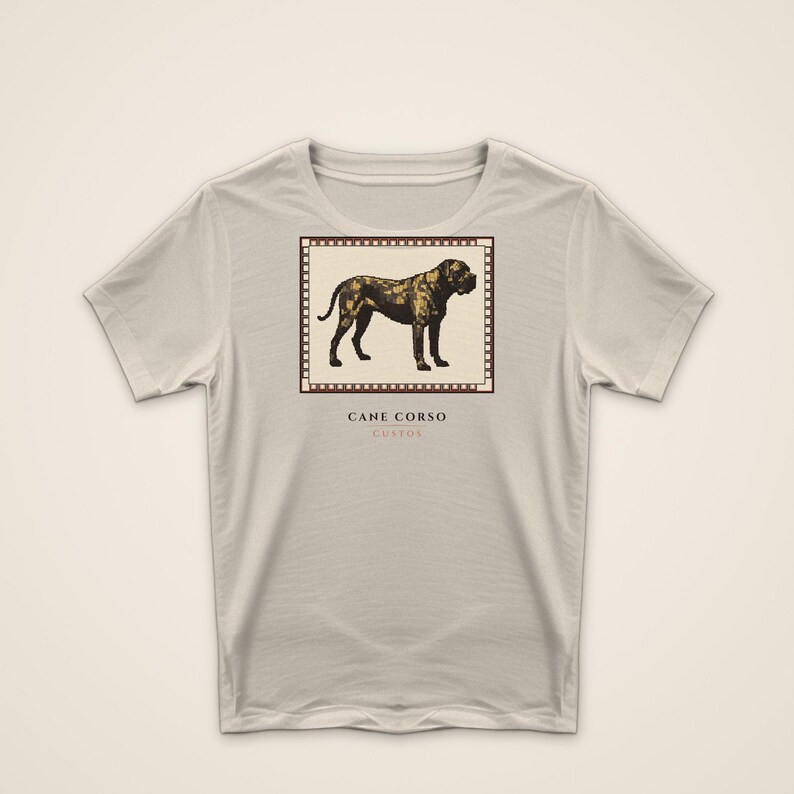 May include: A light beige short-sleeve t-shirt featuring a square graphic of a dark brown Cane Corso dog inside a film strip border. Below the graphic, the text reads CANE CORSO and CUSTOS in a dark brown font centered on the chest area.