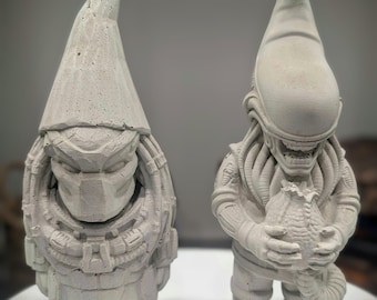 May include: Two light gray concrete garden statues shaped like gnomes. The left figure wears a mask with a textured, armored appearance. The right figure features a creature with an elongated head, exposed teeth, and tentacles, holding a small egg-shaped object.