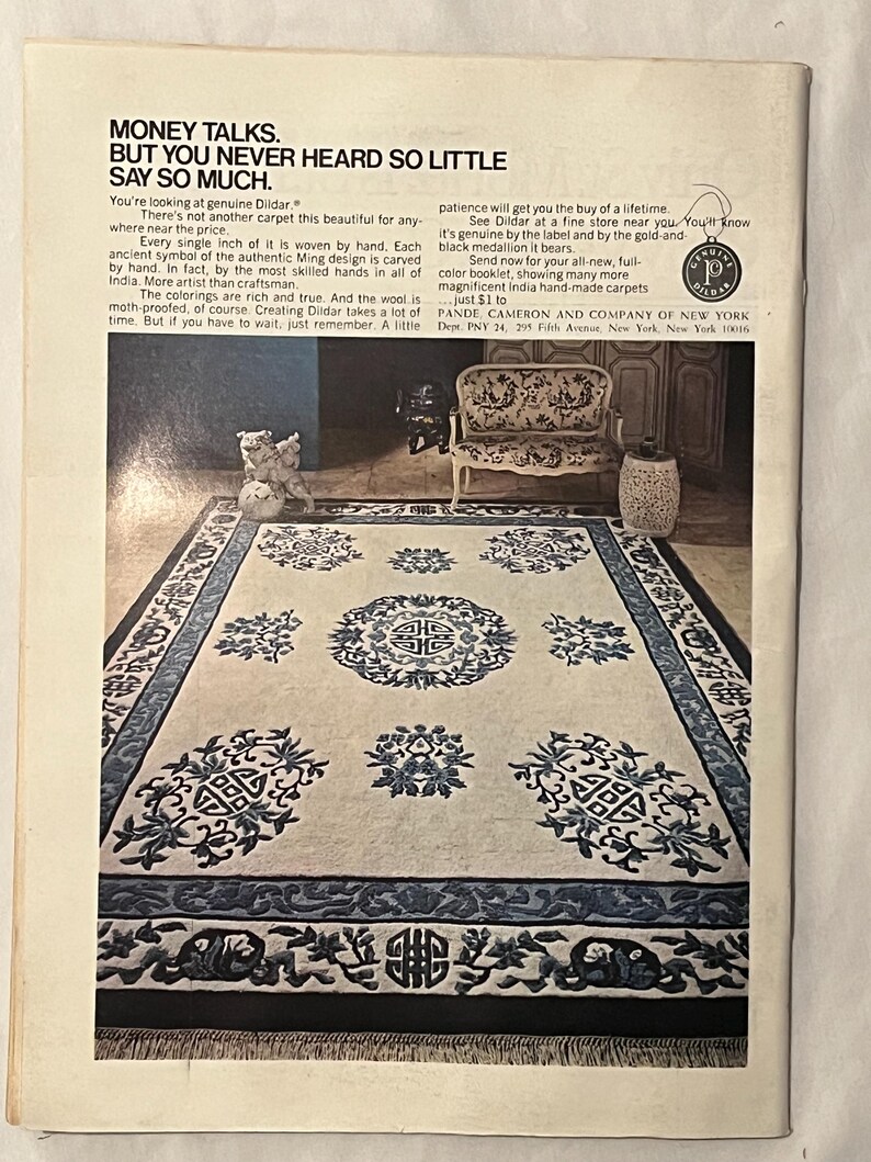 May include: An advertisement for a Dildar carpet. The carpet is cream-colored with a dark blue border and intricate floral and geometric patterns. The text reads "Money Talks. But You Never Heard So Little Say So Much."