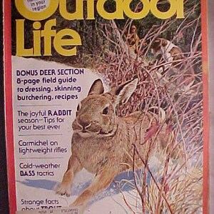 May include: A vintage magazine cover for Outdoor Life magazine from November 1977. The cover features a brown rabbit in a snowy forest setting. The magazine cover text includes "Bonus Deer Section", "The Joyful Rabbit Season", "Carmichel on Lightweight Rifles", "Cold-Weather DASS Tactics", "Strange Facts About Trout", and "Ducks, Moose".