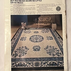 May include: An advertisement for Dildar carpets. The image showcases a large rectangular carpet with a cream-colored background and intricate blue and black patterns. The text reads "Money Talks. But You Never Heard So Little Say So Much."