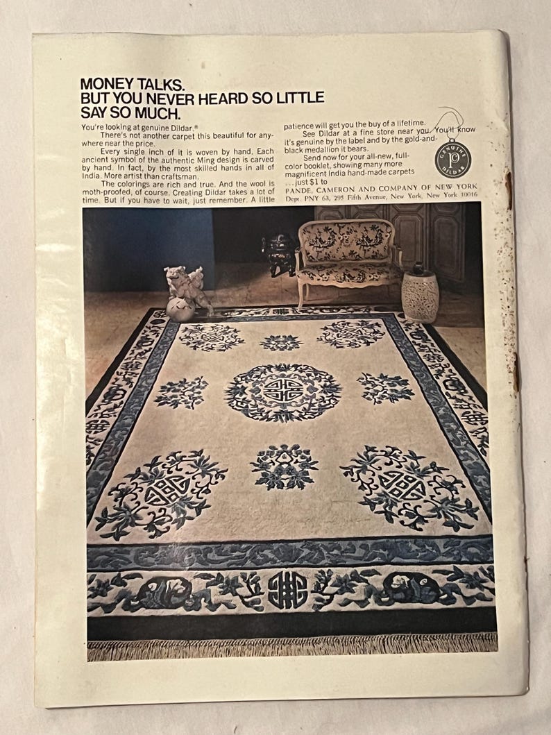 May include: An advertisement for Dildar carpets. The image showcases a large rectangular carpet with a cream-colored background and intricate blue and black patterns. The text reads "Money Talks. But You Never Heard So Little Say So Much."